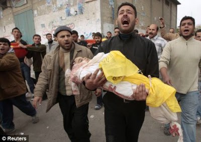 Man carrying his dead child through the streets. Pic via eagle of brass stacks