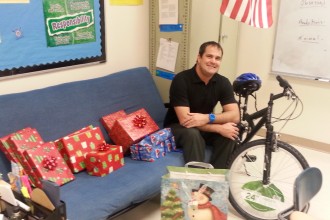 Teacher Justin Voorheis sits amongst the presents he and other teachers bought for his students