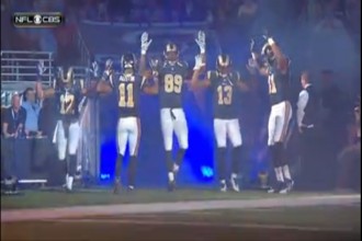 Rams players do "hands up, don't shoot" before their game