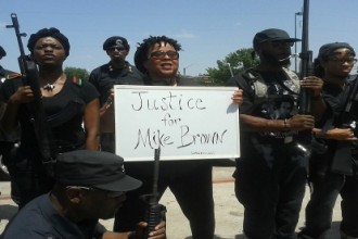 The Huey P. Newton Gun Club of Dallas, TX protests the killing of Michael Brown who was shot and killed by Ferguson, MO police officer Darren Wilson.