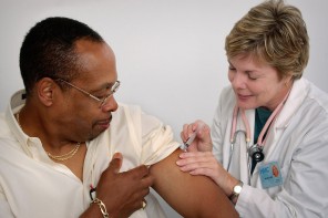 16731-a-nurse-giving-a-middle-aged-man-a-vaccination-shot-pv