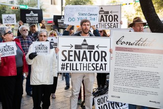 AUSTIN, TX - MARCH 21:  Protesters rally outside of Senator John Cornyn's office building during National Day Of Action calling on Senate Republicans to 'Do Your Job' and uphold their constitutional obligation to give fair consideration to U.S. Supreme Court nominee Judge Merrick Garland on March 21, 2016 in Austin, Texas.  (Photo by Rick Kern/Getty Images for MoveOn.org)