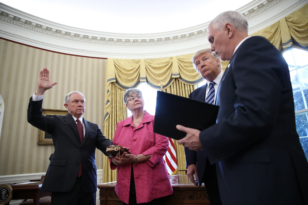 WASHINGTON, DC - FEBRUARY 09:  U.S. President Donald Trump (2nd R) watches as Jeff Sessions (L) is sworn in as the new U.S. Attorney General by U.S. Vice President Mike Pence (R) in the Oval Office of the White House February 9, 2017 in Washington, DC. Trump also signed three executive orders immediately after the swearing in ceremony. Also pictured is Sessions's wife, Mary (2nd L), holding the bible.  (Photo by Win McNamee/Getty Images)